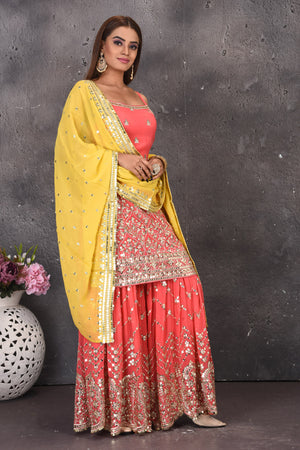 Buy stunning salmon pink mirror work sharara suit online in USA with yellow dupatta. Look stylish at parties and wedding festivities in designer dresses, Indowestern outfits, Anarkali suits, wedding lehengas, palazzo suits, sharara suits from Pure Elegance Indian clothing store in USA.-dupatta