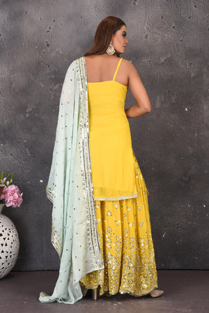 Shop stunning yellow mirror work sharara suit online in USA with powder blue dupatta. Look stylish at parties and wedding festivities in designer dresses, Indowestern outfits, Anarkali suits, wedding lehengas, palazzo suits, sharara suits from Pure Elegance Indian clothing store in USA.-back