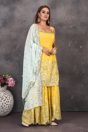 Shop stunning yellow mirror work sharara suit online in USA with powder blue dupatta. Look stylish at parties and wedding festivities in designer dresses, Indowestern outfits, Anarkali suits, wedding lehengas, palazzo suits, sharara suits from Pure Elegance Indian clothing store in USA.-side