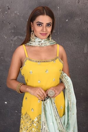 Shop stunning yellow mirror work sharara suit online in USA with powder blue dupatta. Look stylish at parties and wedding festivities in designer dresses, Indowestern outfits, Anarkali suits, wedding lehengas, palazzo suits, sharara suits from Pure Elegance Indian clothing store in USA.-closeup