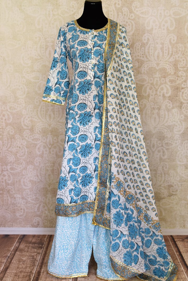 Shop beautiful white and blue Kalamkari palazzo suit online in USA with gota lace. Get set to dazzle on festive occasions in this exquisite designer suits, Anarkali dress, sharara suits, salwar suits, palazzo suits from Pure Elegance Indian fashion store in USA.-full view