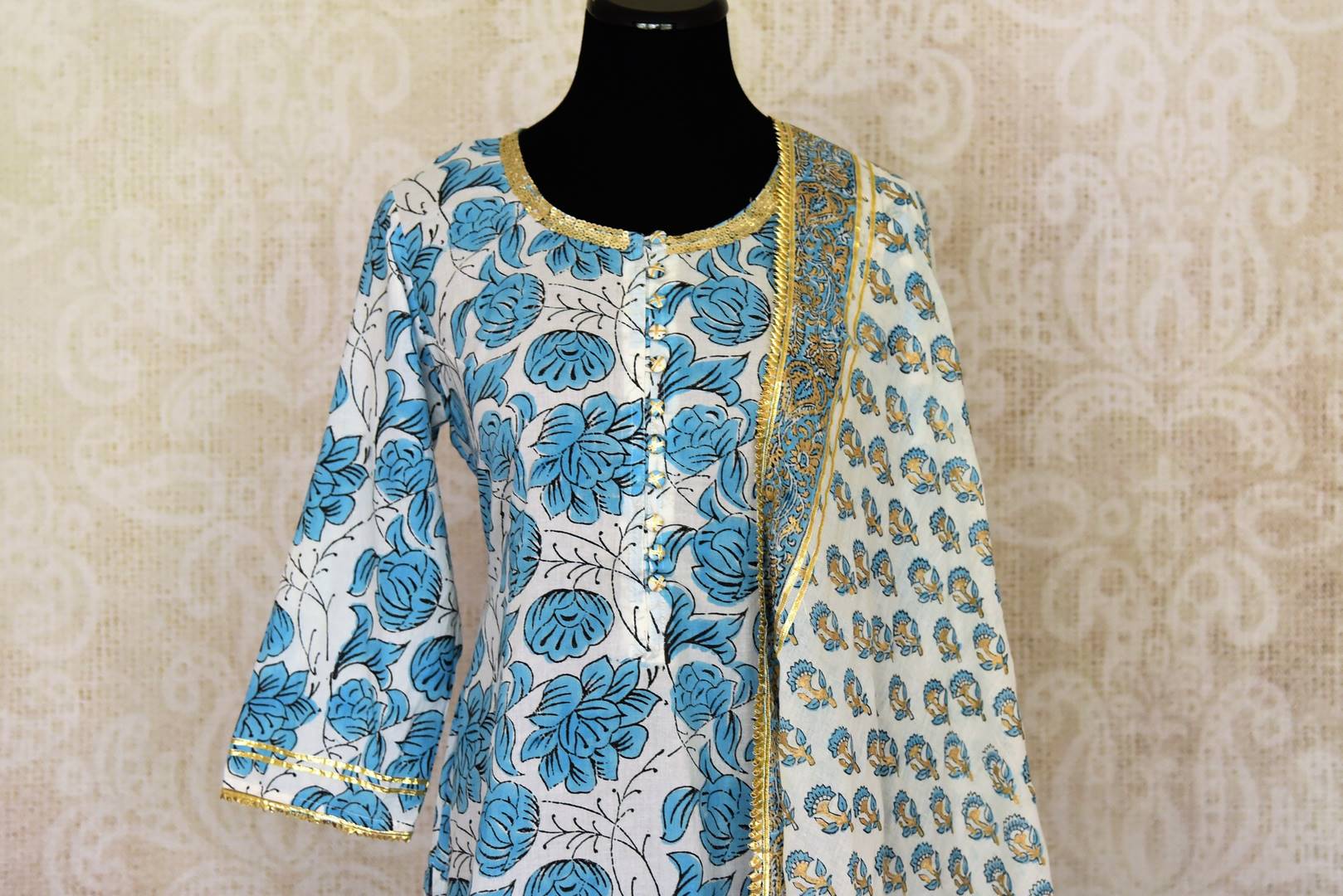 Shop beautiful white and blue Kalamkari palazzo suit online in USA with gota lace. Get set to dazzle on festive occasions in this exquisite designer suits, Anarkali dress, sharara suits, salwar suits, palazzo suits from Pure Elegance Indian fashion store in USA.-closeup