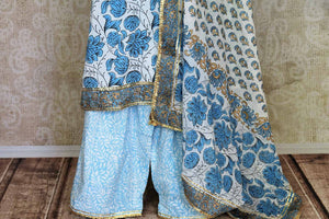 Shop beautiful white and blue Kalamkari palazzo suit online in USA with gota lace. Get set to dazzle on festive occasions in this exquisite designer suits, Anarkali dress, sharara suits, salwar suits, palazzo suits from Pure Elegance Indian fashion store in USA.-palazzo