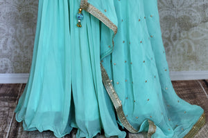 Shop stunning pastel blue embroidered sharara suit online in USA with dupatta. Get set to dazzle on festive occasions in this exquisite designer suits, Anarkali dress, sharara suits, salwar suits, palazzo suits from Pure Elegance Indian fashion store in USA.-palazzo