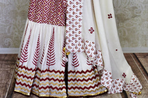 Buy beautiful white Kalamkari cotton sharara suit online in USA with mirror work. Get set to dazzle on festive occasions in this exquisite designer suits, Anarkali dress, sharara suits, salwar suits, palazzo suits from Pure Elegance Indian fashion store in USA.-palazzo
