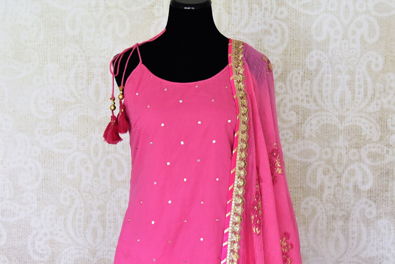 Buy beautiful pink cotton sharara suit online in USA with gota work and dupatta. Get set to dazzle on festive occasions in this exquisite designer suits, Anarkali dress, sharara suits, salwar suits, palazzo suits from Pure Elegance Indian fashion store in USA.-closeup