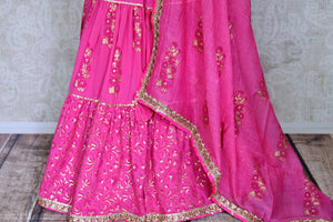 Buy beautiful pink cotton sharara suit online in USA with gota work and dupatta. Get set to dazzle on festive occasions in this exquisite designer suits, Anarkali dress, sharara suits, salwar suits, palazzo suits from Pure Elegance Indian fashion store in USA.-sharara