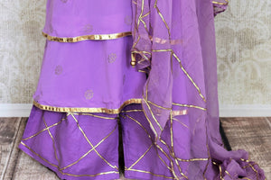 Shop beautiful lavender georgette sharara suit online in USA with gota work and dupatta. Get set to dazzle on festive occasions in this exquisite designer suits, Anarkali dress, sharara suits, salwar suits, palazzo suits from Pure Elegance Indian fashion store in USA.-sharara