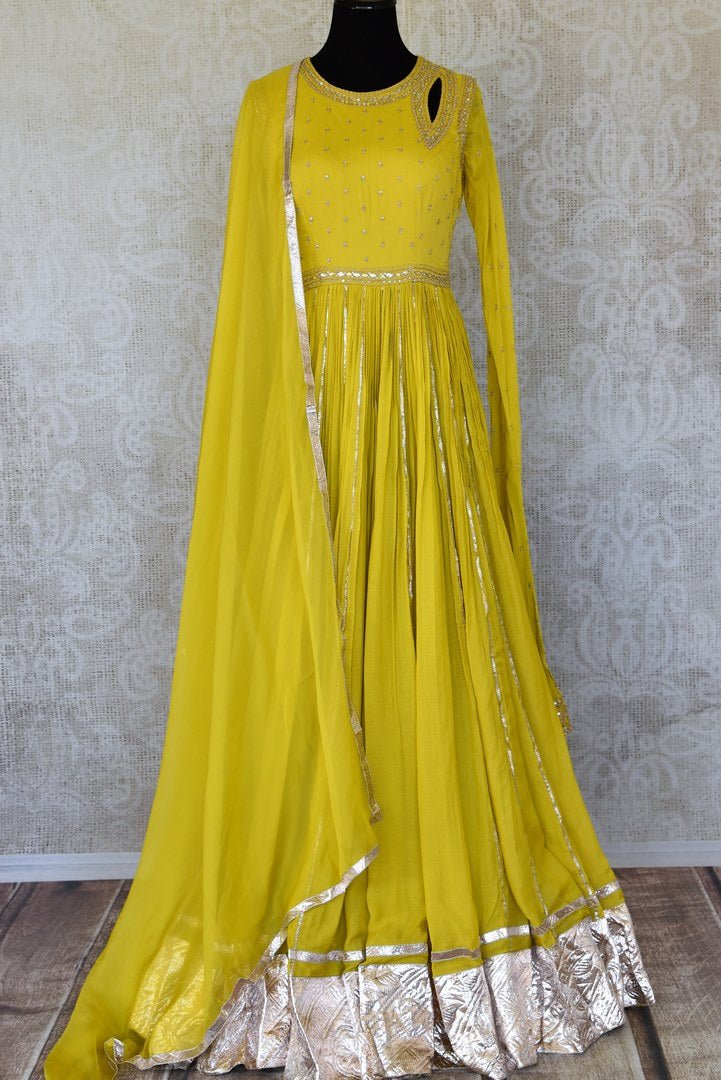 Shop beautiful bright yellow silk Anarkali suit online in USA with gota work. Add an elegant touch to your ethnic style with beautiful designer suits, Anarkali suits, gharara suits, salwar suits, sharara suits from Pure Elegance Indian fashion store in USA.-full view