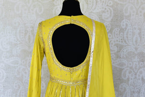 Shop beautiful bright yellow silk Anarkali suit online in USA with gota work. Add an elegant touch to your ethnic style with beautiful designer suits, Anarkali suits, gharara suits, salwar suits, sharara suits from Pure Elegance Indian fashion store in USA.-back