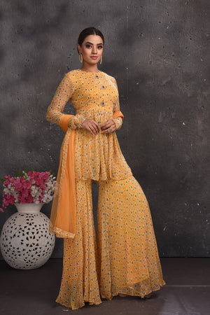Shop stunning pastel orange printed gharara suit online in USA. Look your best at weddings and special occasions in exclusive designer lehengas, Anarkali suits, sharara suits. designer gowns and Indian dresses from Pure Elegance Indian fashion store in USA.-side