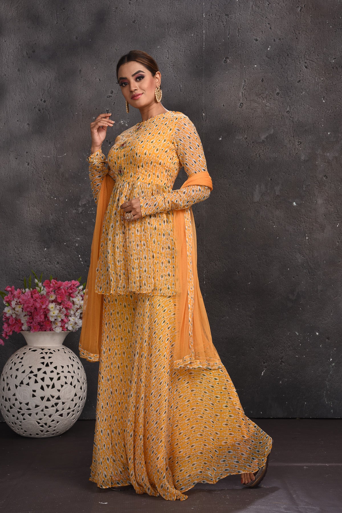Shop stunning pastel orange printed gharara suit online in USA. Look your best at weddings and special occasions in exclusive designer lehengas, Anarkali suits, sharara suits. designer gowns and Indian dresses from Pure Elegance Indian fashion store in USA.-left