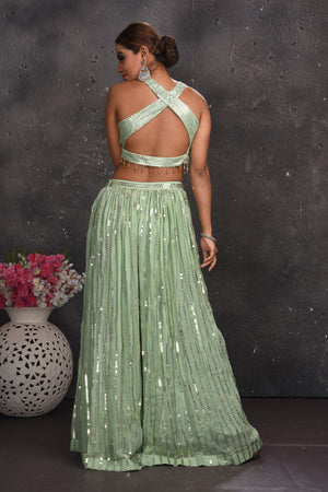 Buy beautiful sage green embellished palazzo crop top online in USA with dupatta. Look your best at weddings and special occasions in exclusive designer lehengas, Anarkali suits, sharara suits. designer gowns and Indian dresses from Pure Elegance Indian fashion store in USA.-back