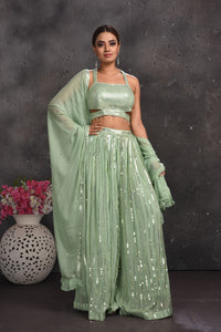 Buy beautiful sage green embellished palazzo crop top online in USA with dupatta. Look your best at weddings and special occasions in exclusive designer lehengas, Anarkali suits, sharara suits. designer gowns and Indian dresses from Pure Elegance Indian fashion store in USA.-full view