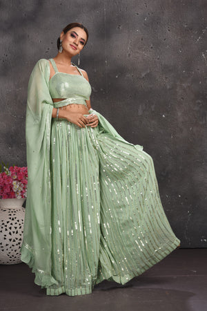 Buy beautiful sage green embellished palazzo crop top online in USA with dupatta. Look your best at weddings and special occasions in exclusive designer lehengas, Anarkali suits, sharara suits. designer gowns and Indian dresses from Pure Elegance Indian fashion store in USA.-right