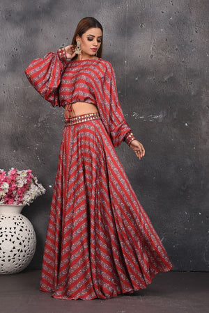 Shop stunning red printed mirror work skirt with crop top online in USA. Look your best at weddings and special occasions in exclusive designer lehengas, Anarkali suits, sharara suits. designer gowns and Indian dresses from Pure Elegance Indian fashion store in USA.-side
