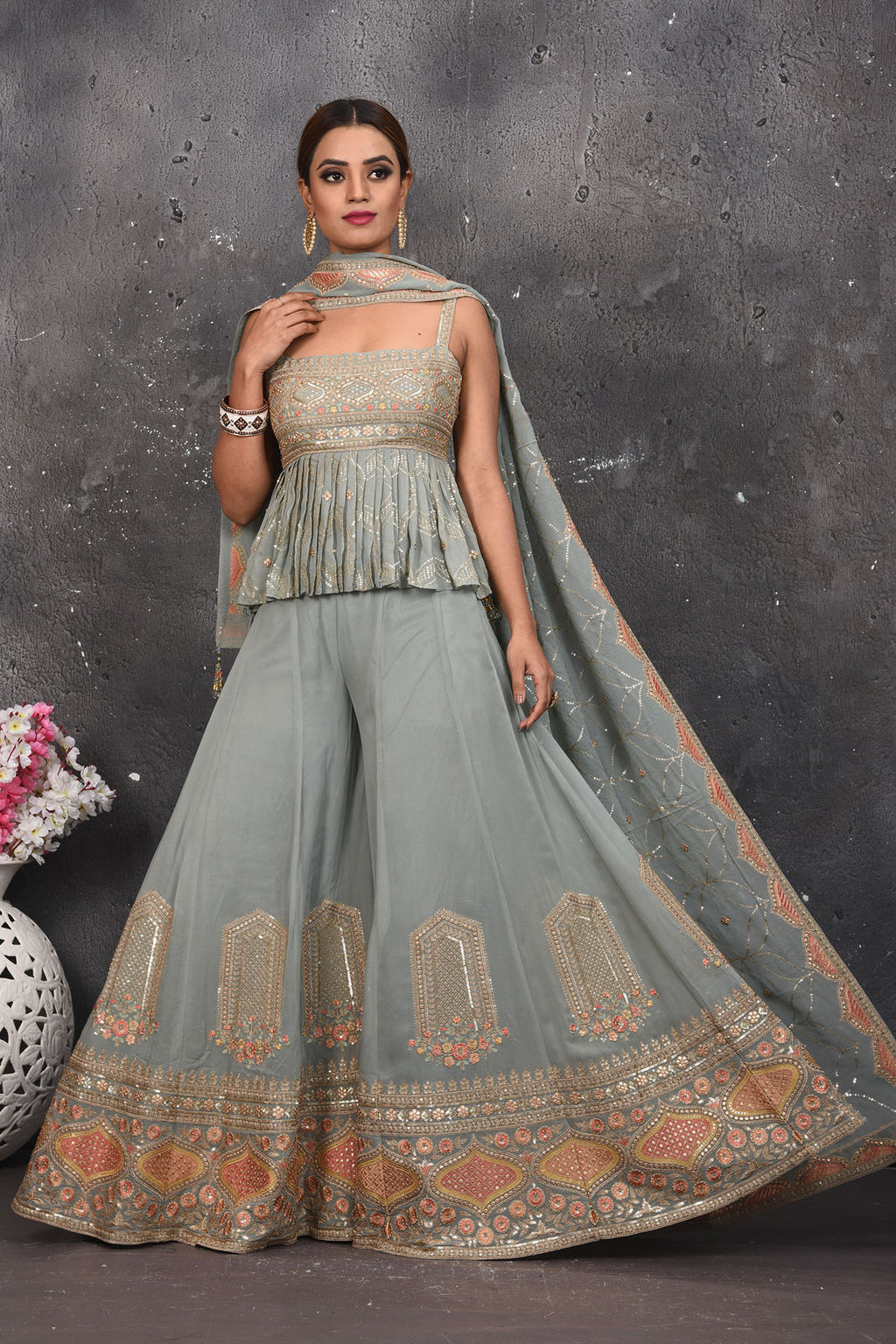 Shop stunning light grey embroidered peplum sharara suit online in USA. Look your best at weddings and special occasions in exclusive designer lehengas, Anarkali suits, sharara suits. designer gowns and Indian dresses from Pure Elegance Indian fashion store in USA.-full view