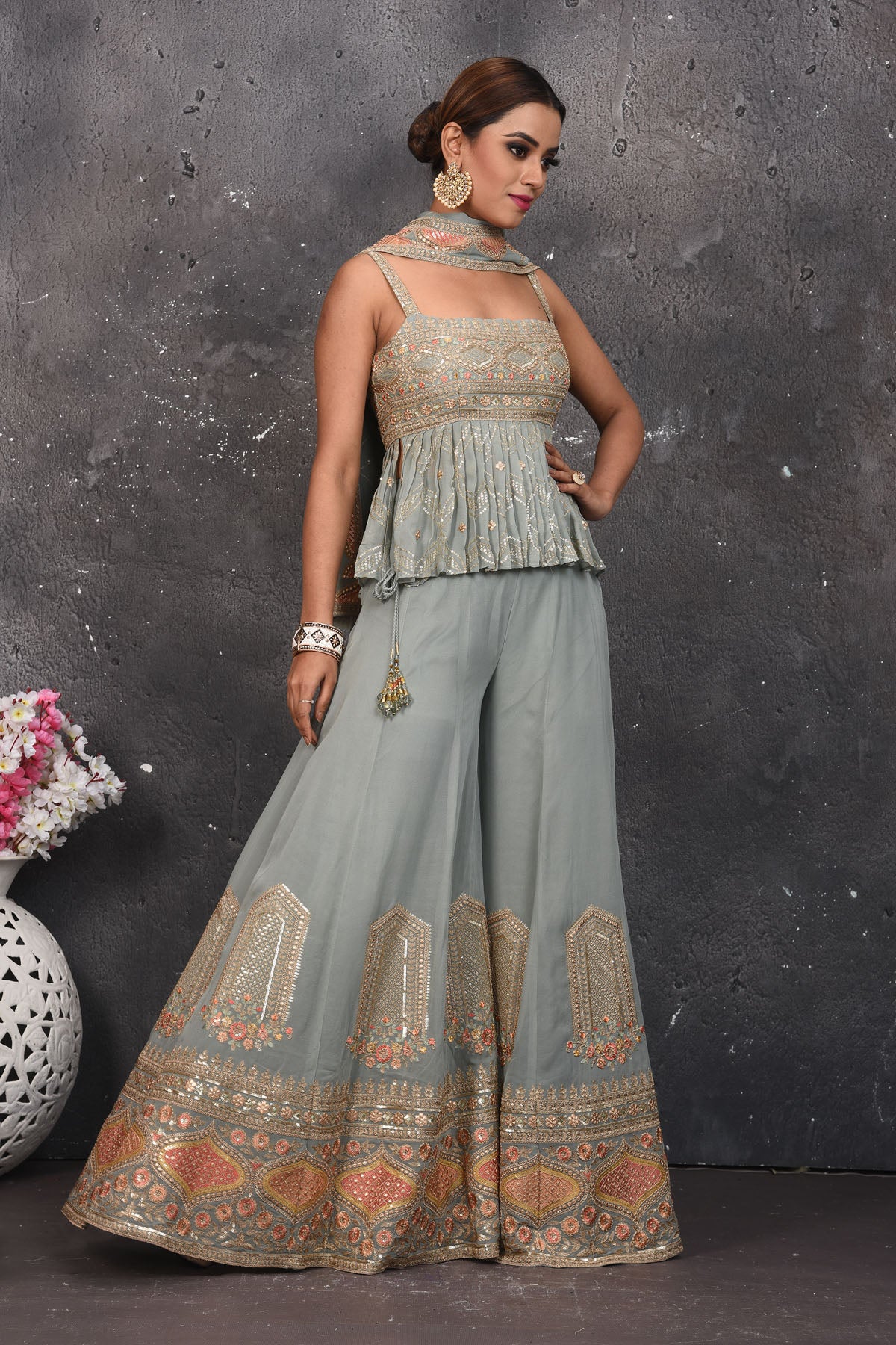 Shop stunning light grey embroidered peplum sharara suit online in USA. Look your best at weddings and special occasions in exclusive designer lehengas, Anarkali suits, sharara suits. designer gowns and Indian dresses from Pure Elegance Indian fashion store in USA.-side