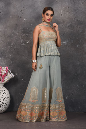 Shop stunning light grey embroidered peplum sharara suit online in USA. Look your best at weddings and special occasions in exclusive designer lehengas, Anarkali suits, sharara suits. designer gowns and Indian dresses from Pure Elegance Indian fashion store in USA.-palazzo