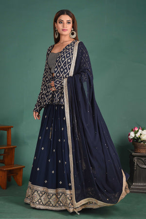 Shop stunning dark blue designer lehenga online in USA with jacket and dupatta. Dazzle on weddings and special occasions with exquisite Indian designer dresses, sharara suits, designer lehengas Anarkali suits, wedding lehengas from Pure Elegance Indian fashion store in USA.-left