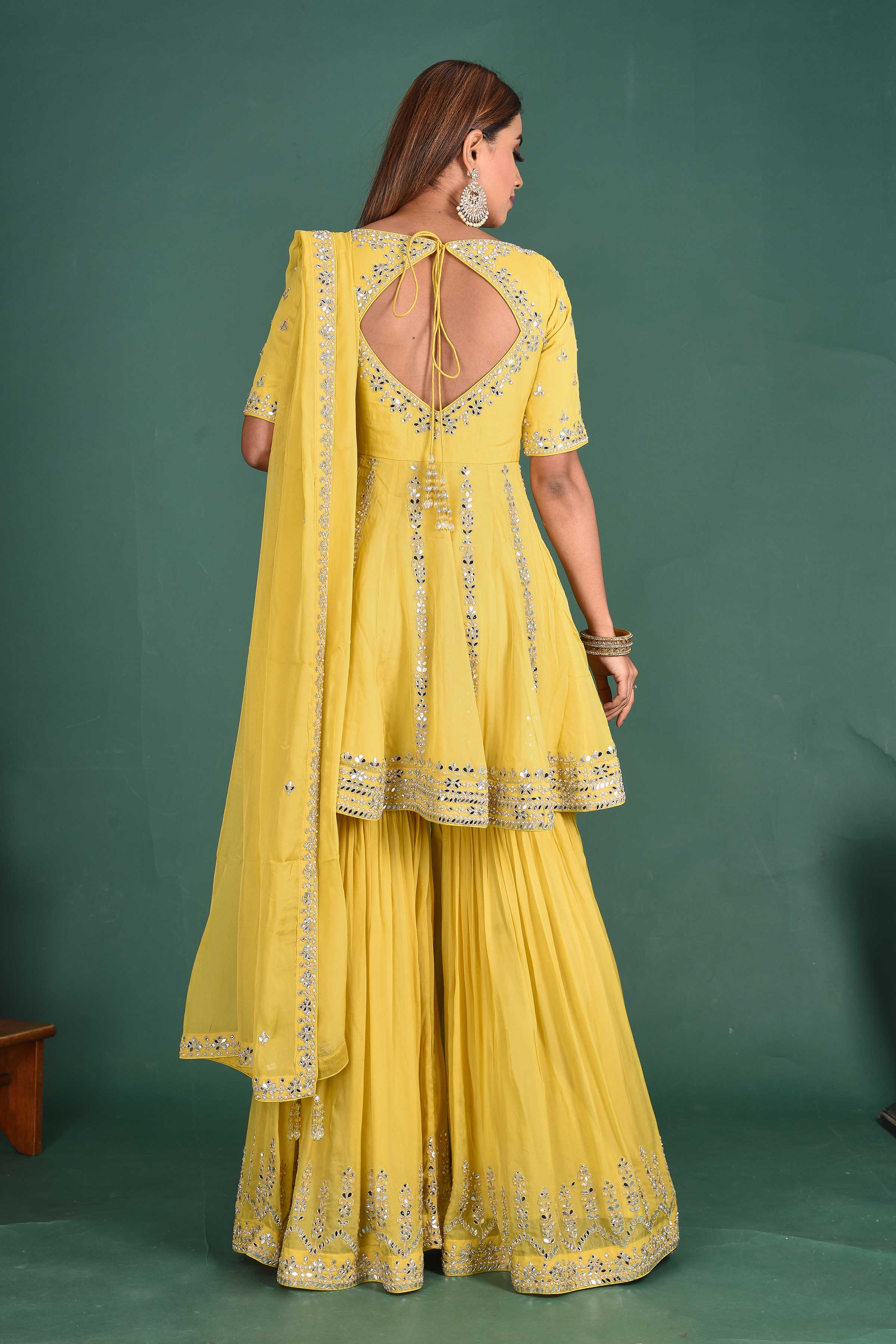 Buy beautiful yellow embroidered peplum sharara suit online in USA with dupatta. Dazzle on weddings and special occasions with exquisite Indian designer dresses, sharara suits, designer lehengas Anarkali suits, wedding lehengas from Pure Elegance Indian fashion store in USA.-back