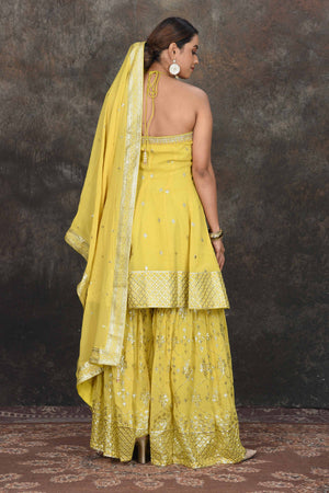 Shop stunning yellow halter neck embroidered sharara suit online in USA with dupatta. Dazzle at sangeet and wedding occasions in this beautiful designer lehengas, Anarkali suits, sharara suit, bridal gowns, bridal lehengas from Pure Elegance Indian fashion store in USA.-back