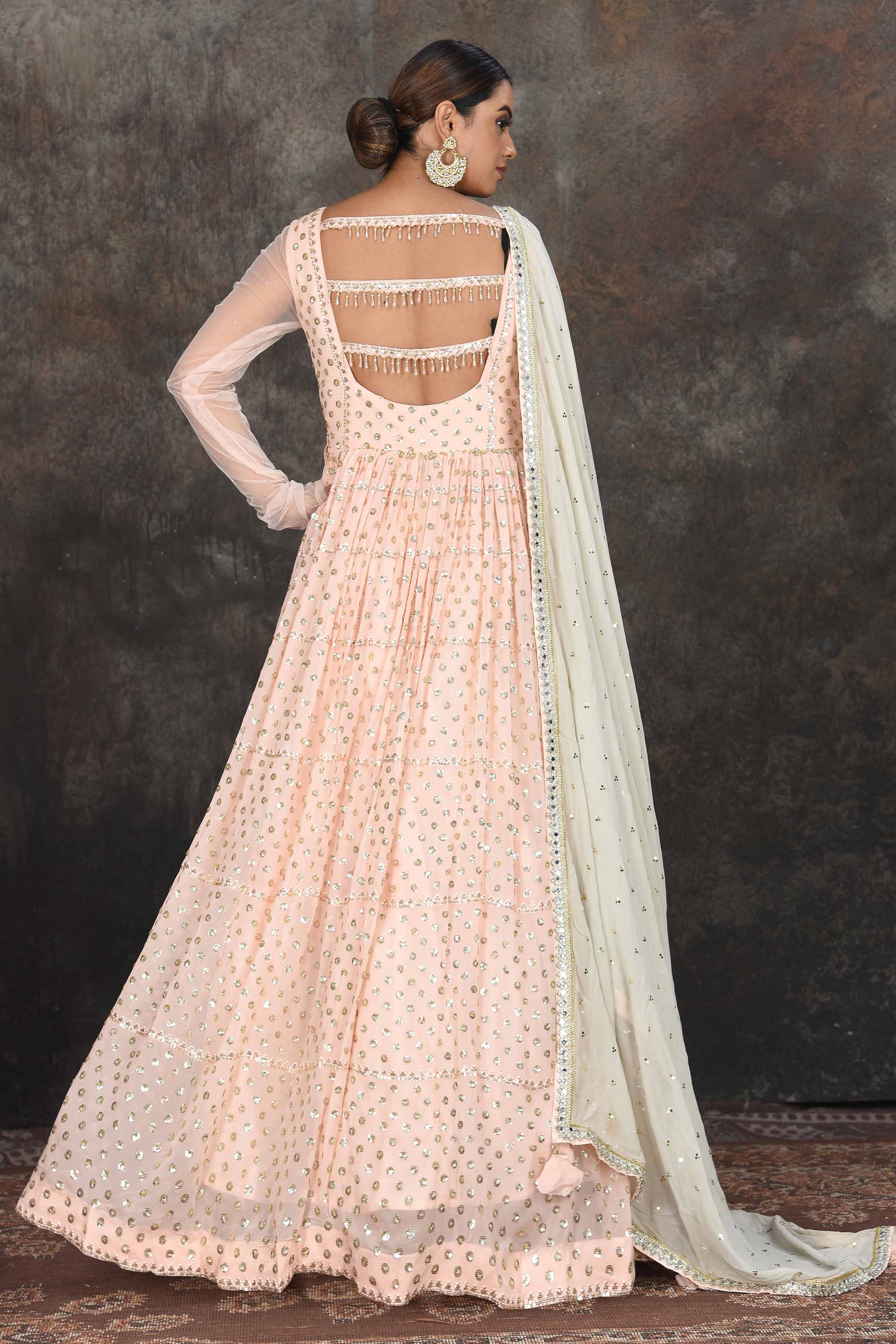 Buy beautiful light peach embroidered Anarkali suit online in USA with mint green embroidered dupatta. Dazzle at sangeet and wedding occasions in this beautiful designer lehengas, Anarkali suits, sharara suit, bridal gowns, bridal lehengas from Pure Elegance Indian fashion store in USA.-back
