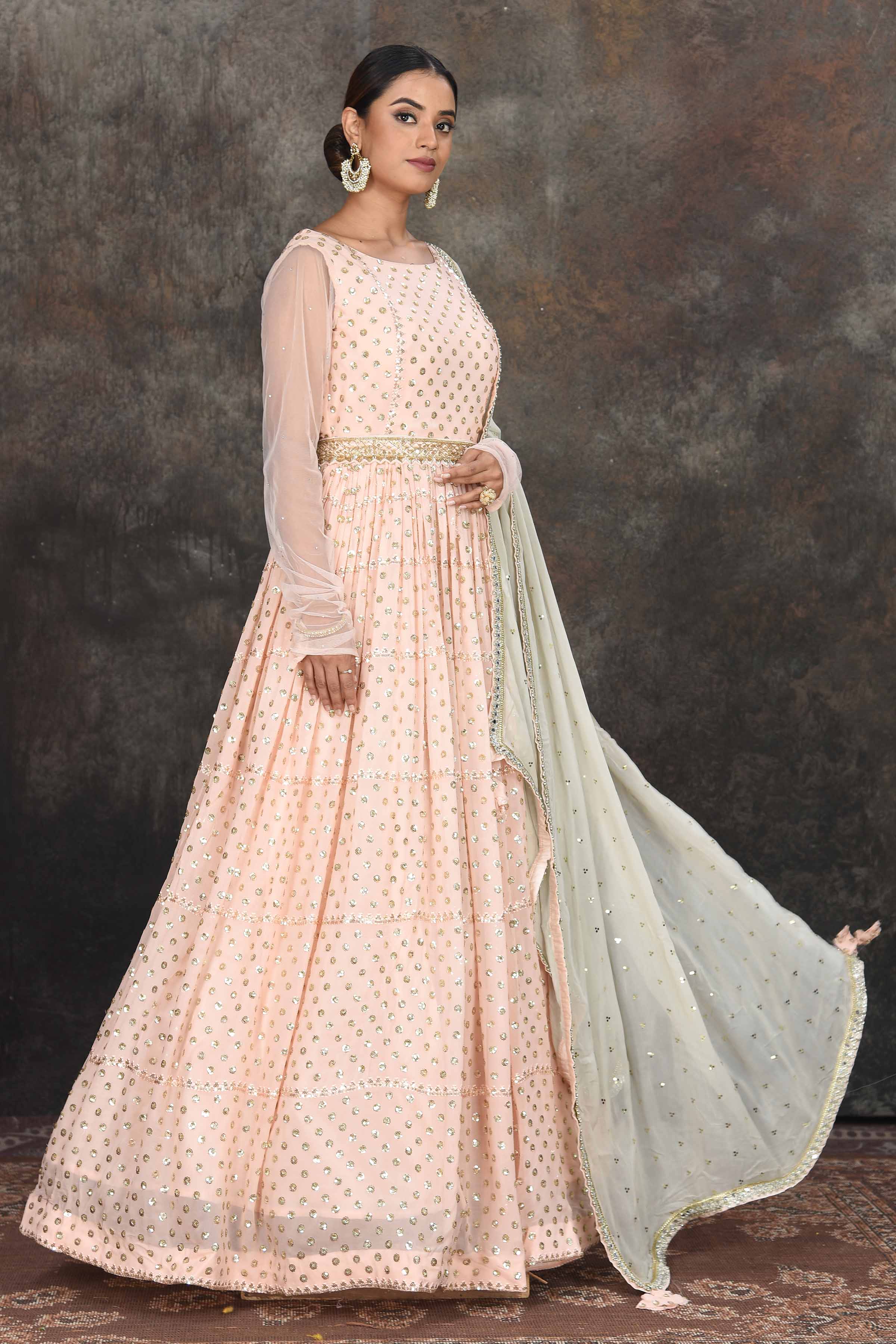 Buy beautiful light peach embroidered Anarkali suit online in USA with mint green embroidered dupatta. Dazzle at sangeet and wedding occasions in this beautiful designer lehengas, Anarkali suits, sharara suit, bridal gowns, bridal lehengas from Pure Elegance Indian fashion store in USA.-side