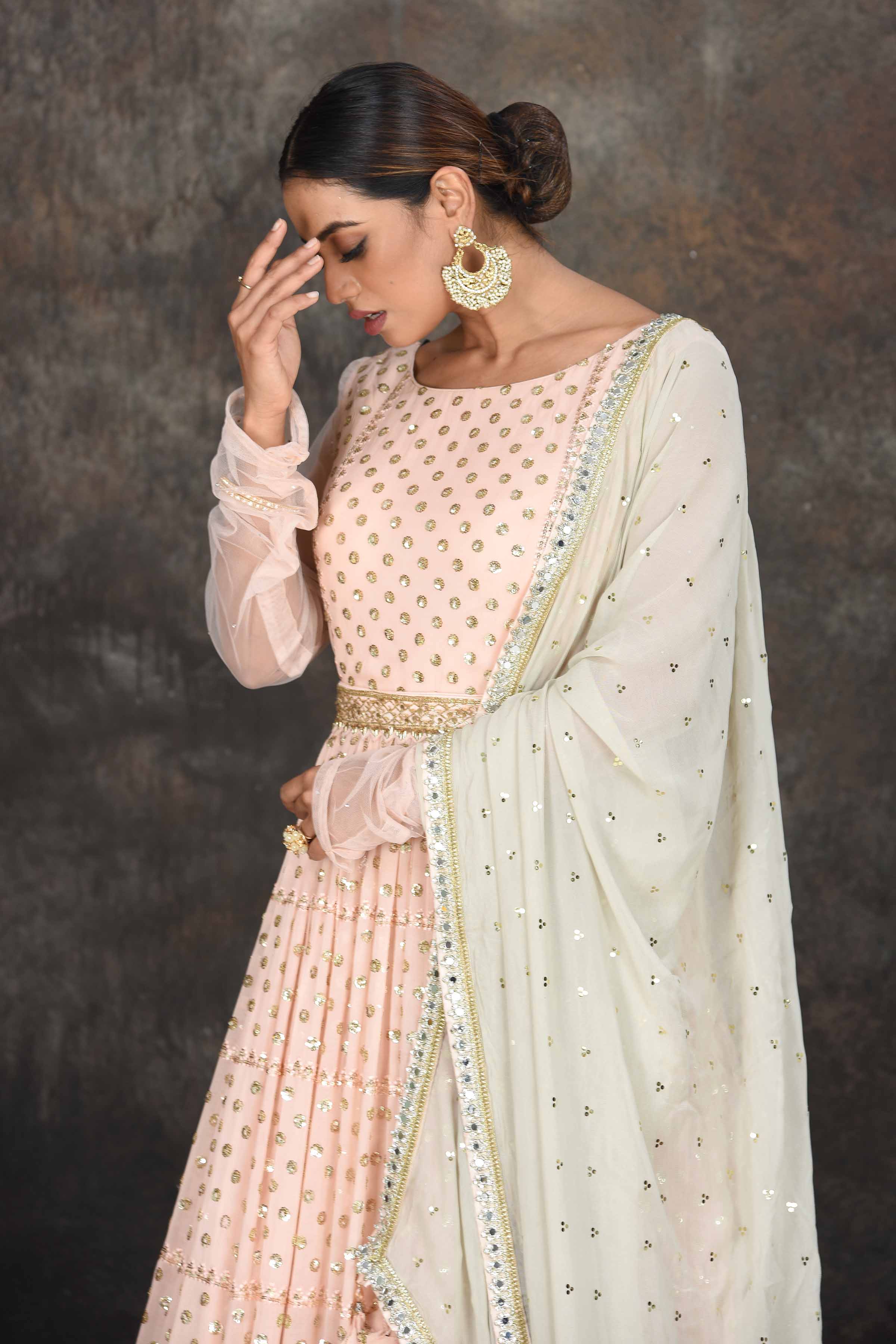 Buy beautiful light peach embroidered Anarkali suit online in USA with mint green embroidered dupatta. Dazzle at sangeet and wedding occasions in this beautiful designer lehengas, Anarkali suits, sharara suit, bridal gowns, bridal lehengas from Pure Elegance Indian fashion store in USA.-closeup