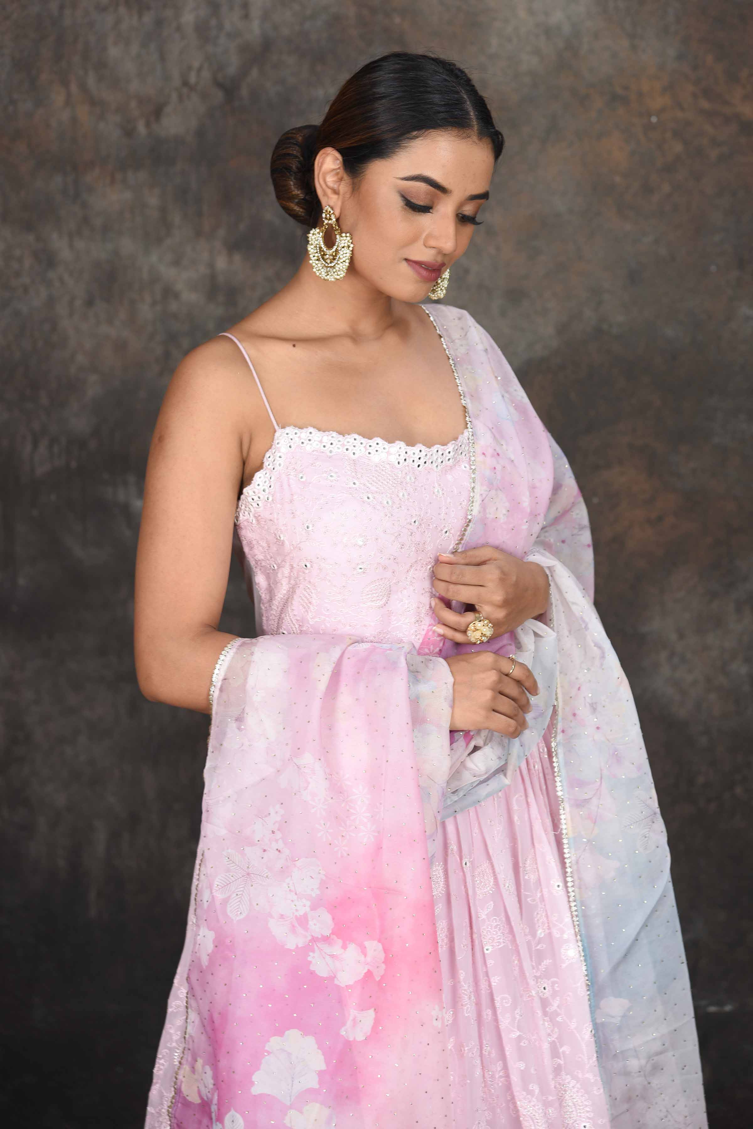 Buy stunning powder pink embroidered Anarkali suit online in USA with floral dupatta. Dazzle at sangeet and wedding occasions in this beautiful designer lehengas, Anarkali suits, sharara suit, bridal gowns, bridal lehengas from Pure Elegance Indian fashion store in USA.-closeup