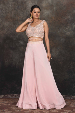 Buy stunning powder pink applique work crop top online in USA with palazzo. Dazzle at sangeet and wedding occasions in this beautiful designer lehengas, Anarkali suits, sharara suit, bridal gowns, bridal lehengas from Pure Elegance Indian fashion store in USA.-side