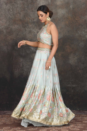Shop stunning sage green embroidered halter neck lehenga online in USA. Dazzle at sangeet and wedding occasions in this beautiful designer lehengas, Anarkali suits, sharara suit, bridal gowns, bridal lehengas from Pure Elegance Indian fashion store in USA.-left