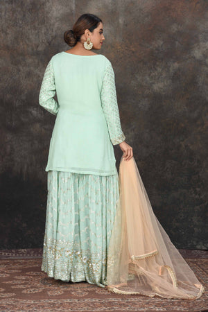 Shop beautiful mint green embroidered sharara suit online in USA with peach dupatta. Dazzle at sangeet and wedding occasions in this beautiful designer lehengas, Anarkali suits, sharara suit, bridal gowns, bridal lehengas from Pure Elegance Indian fashion store in USA.-back