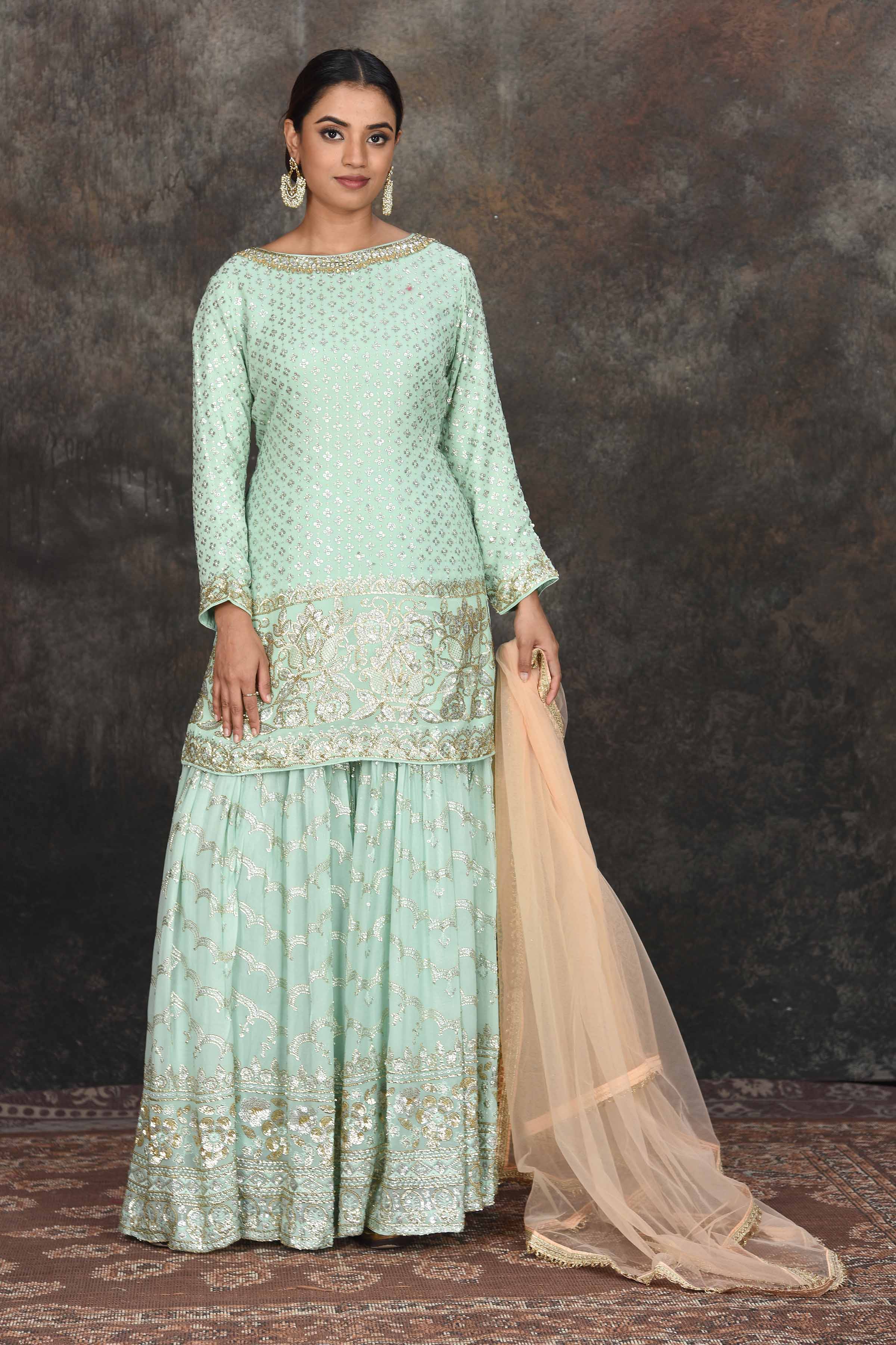 Shop beautiful mint green embroidered sharara suit online in USA with peach dupatta. Dazzle at sangeet and wedding occasions in this beautiful designer lehengas, Anarkali suits, sharara suit, bridal gowns, bridal lehengas from Pure Elegance Indian fashion store in USA.-full view