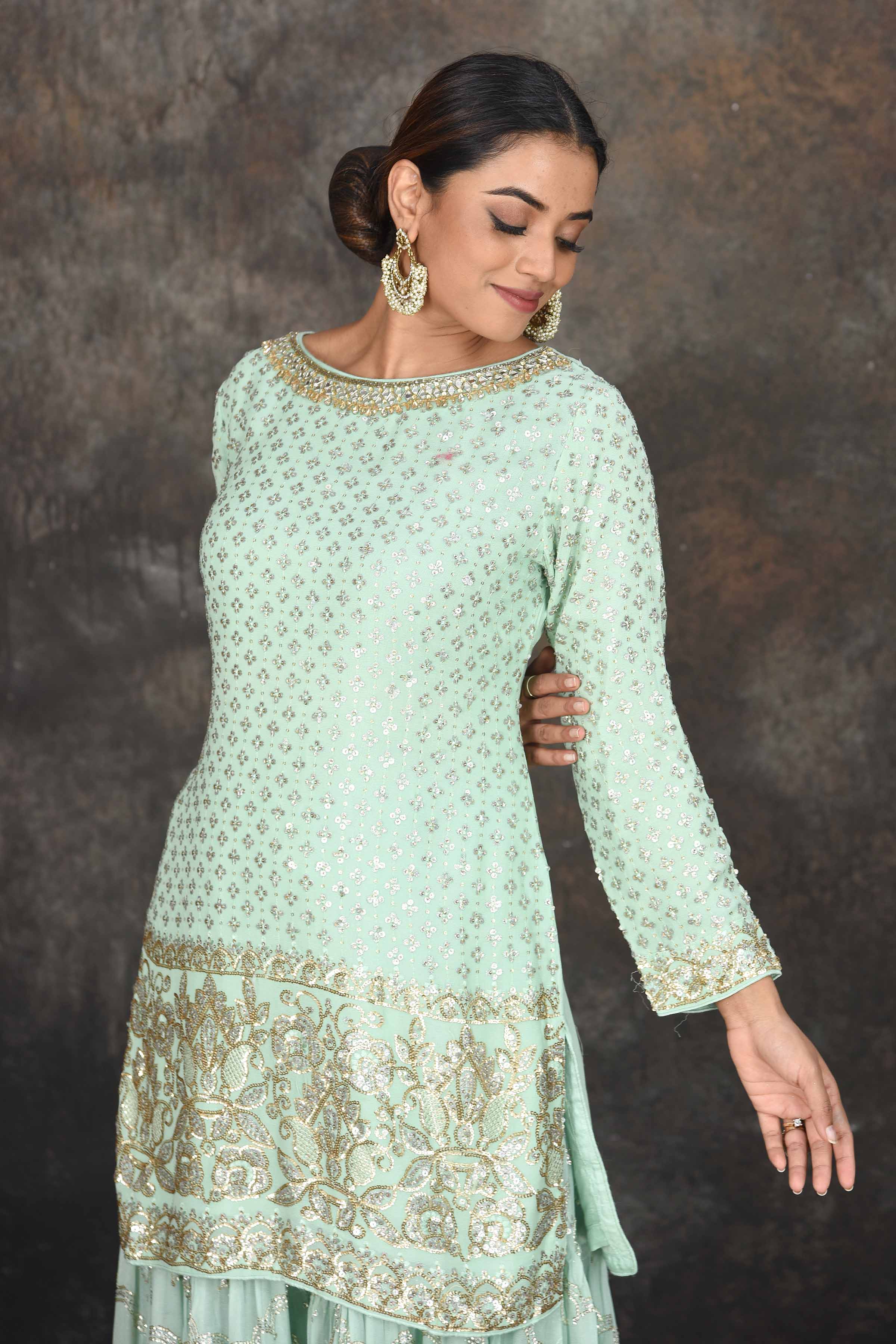 Shop beautiful mint green embroidered sharara suit online in USA with peach dupatta. Dazzle at sangeet and wedding occasions in this beautiful designer lehengas, Anarkali suits, sharara suit, bridal gowns, bridal lehengas from Pure Elegance Indian fashion store in USA.-closeup