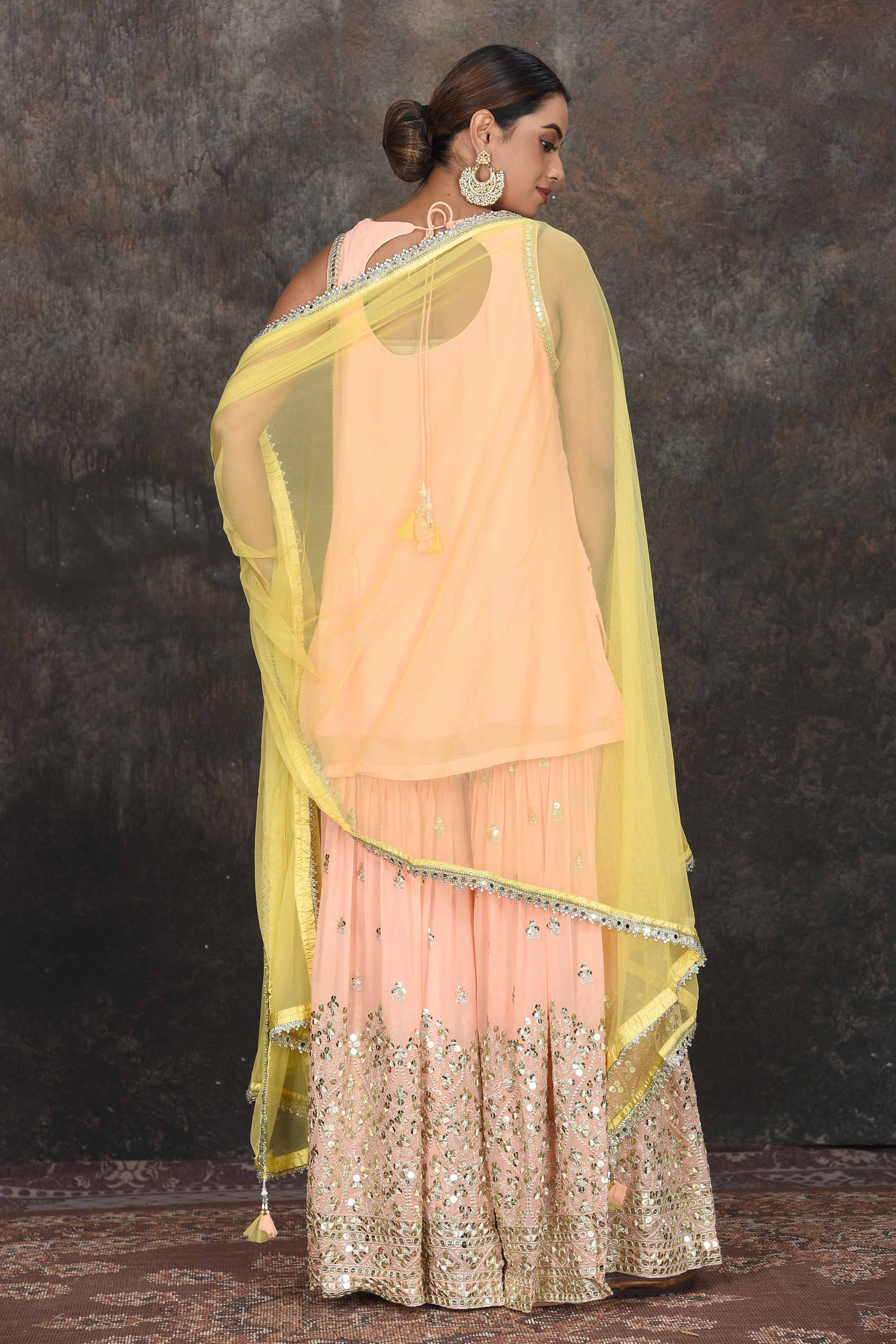 Shop beautiful peach embroidered sharara suit online in USA with yellow dupatta. Dazzle at sangeet and wedding occasions in this beautiful designer lehengas, Anarkali suits, sharara suit, bridal gowns, bridal lehengas from Pure Elegance Indian fashion store in USA.-back