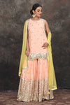 Shop beautiful peach embroidered sharara suit online in USA with yellow dupatta. Dazzle at sangeet and wedding occasions in this beautiful designer lehengas, Anarkali suits, sharara suit, bridal gowns, bridal lehengas from Pure Elegance Indian fashion store in USA.-full view