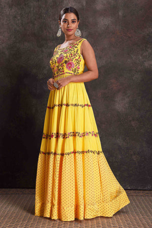 Buy beautiful yellow embroidered sleeveless party gown online in USA. Look your ethnic best on festive occasions with latest designer sarees, pure silk sarees, Kanchipuram silk sarees, designer dresses, Anarkali suits, gown, embroidered sarees from Pure Elegance Indian fashion store in USA.-left