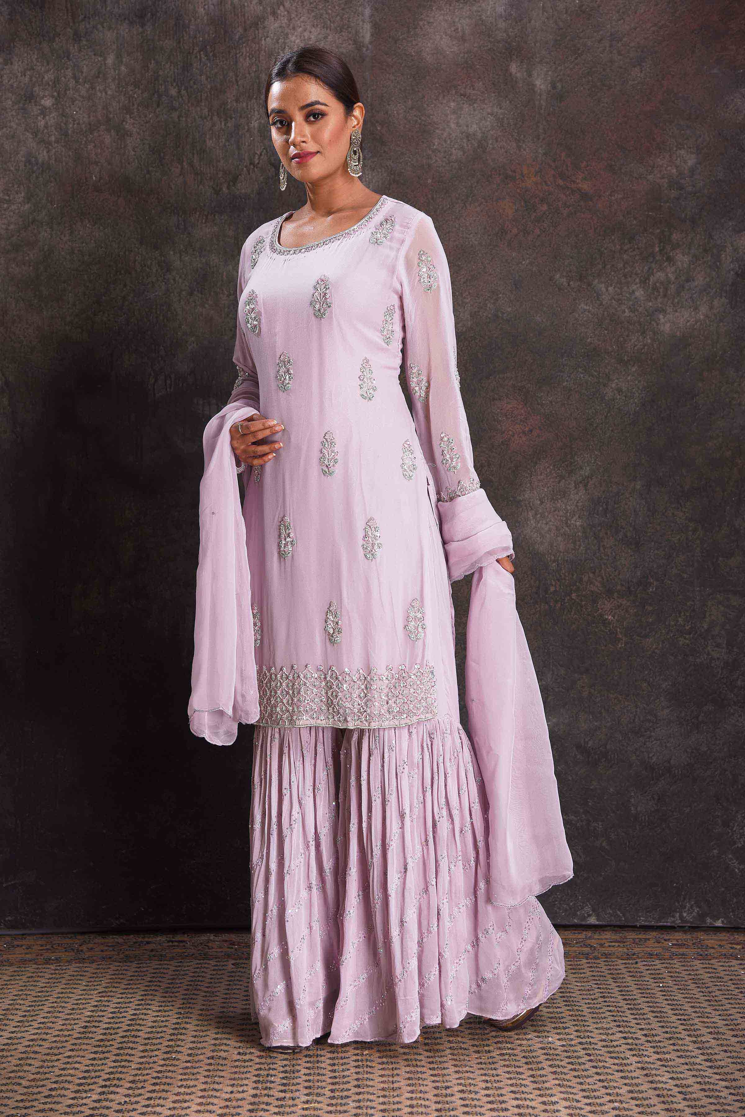 Shop stunning lilac embroidered sharara suit online in USA with dupatta. Look your ethnic best on festive occasions with latest designer sarees, pure silk sarees, Kanchipuram silk sarees, designer dresses, Anarkali suits, gown, embroidered sarees from Pure Elegance Indian fashion store in USA.-left