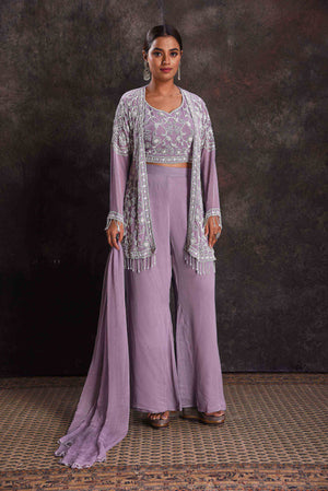 Shop beautiful lavender embroidered crop top and palazzo online in USA with shrug. Look your ethnic best on festive occasions with latest designer sarees, pure silk sarees, Kanchipuram silk sarees, designer dresses, Anarkali suits, gown, embroidered sarees from Pure Elegance Indian fashion store in USA.-front