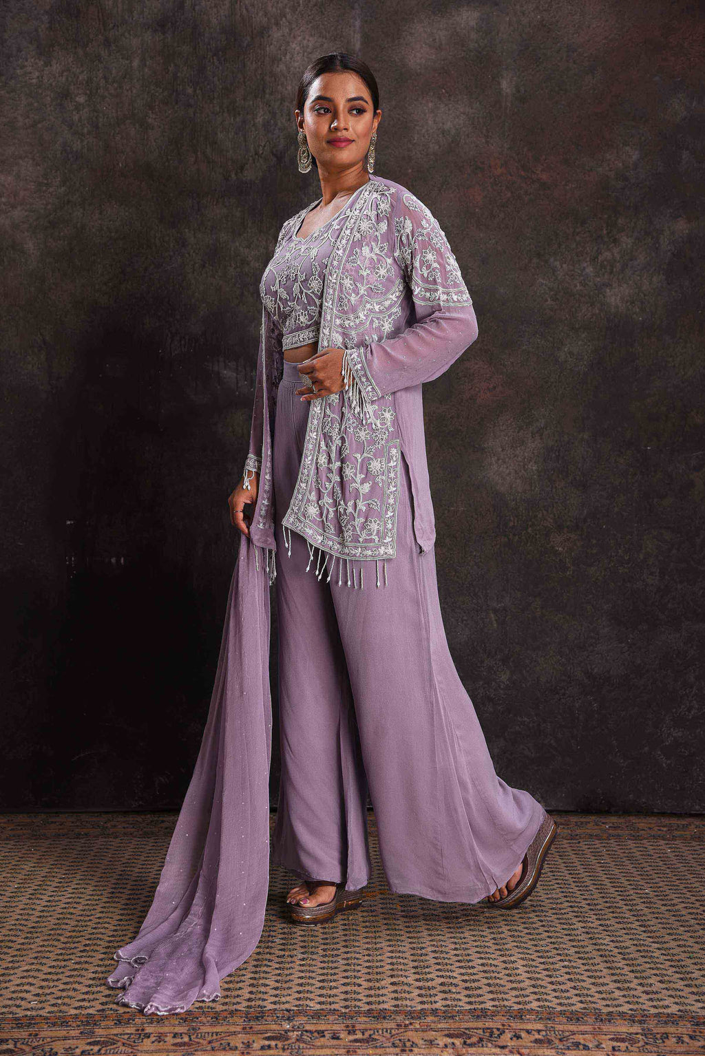 Shop beautiful lavender embroidered crop top and palazzo online in USA with shrug. Look your ethnic best on festive occasions with latest designer sarees, pure silk sarees, Kanchipuram silk sarees, designer dresses, Anarkali suits, gown, embroidered sarees from Pure Elegance Indian fashion store in USA.-full view