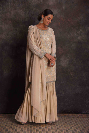 Shop stunning cream embroidered gharara suit online in USA with dupatta. Look your ethnic best on festive occasions with latest designer sarees, pure silk sarees, Kanchipuram silk sarees, designer dresses, Anarkali suits, gown, embroidered sarees from Pure Elegance Indian fashion store in USA.-right