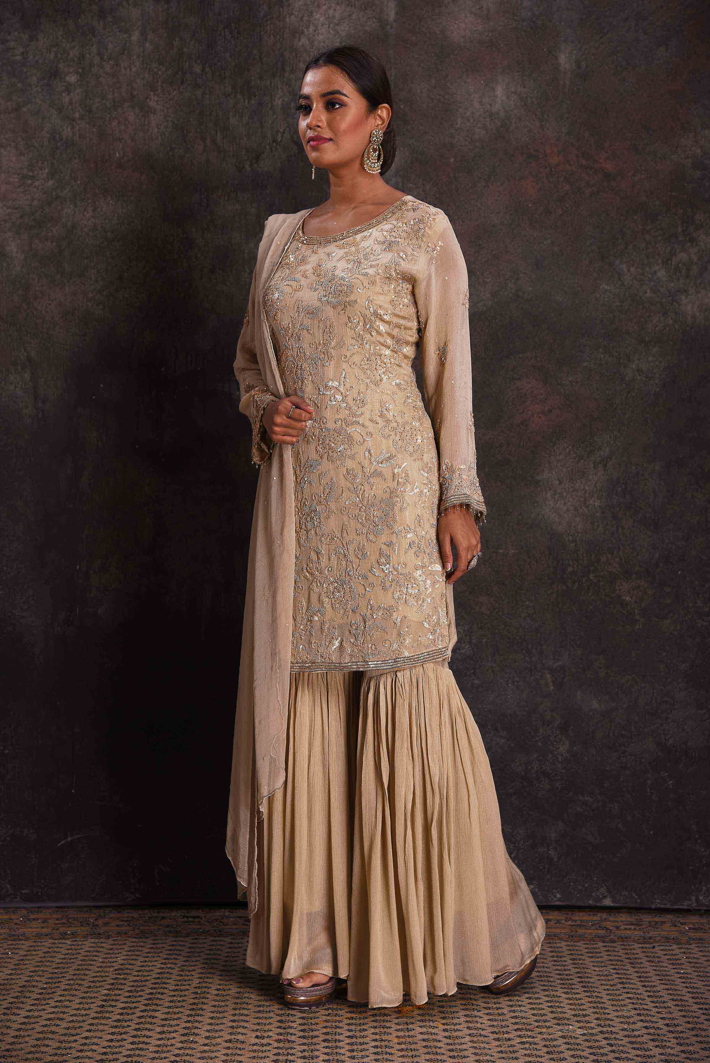 Shop stunning cream embroidered gharara suit online in USA with dupatta. Look your ethnic best on festive occasions with latest designer sarees, pure silk sarees, Kanchipuram silk sarees, designer dresses, Anarkali suits, gown, embroidered sarees from Pure Elegance Indian fashion store in USA.-left