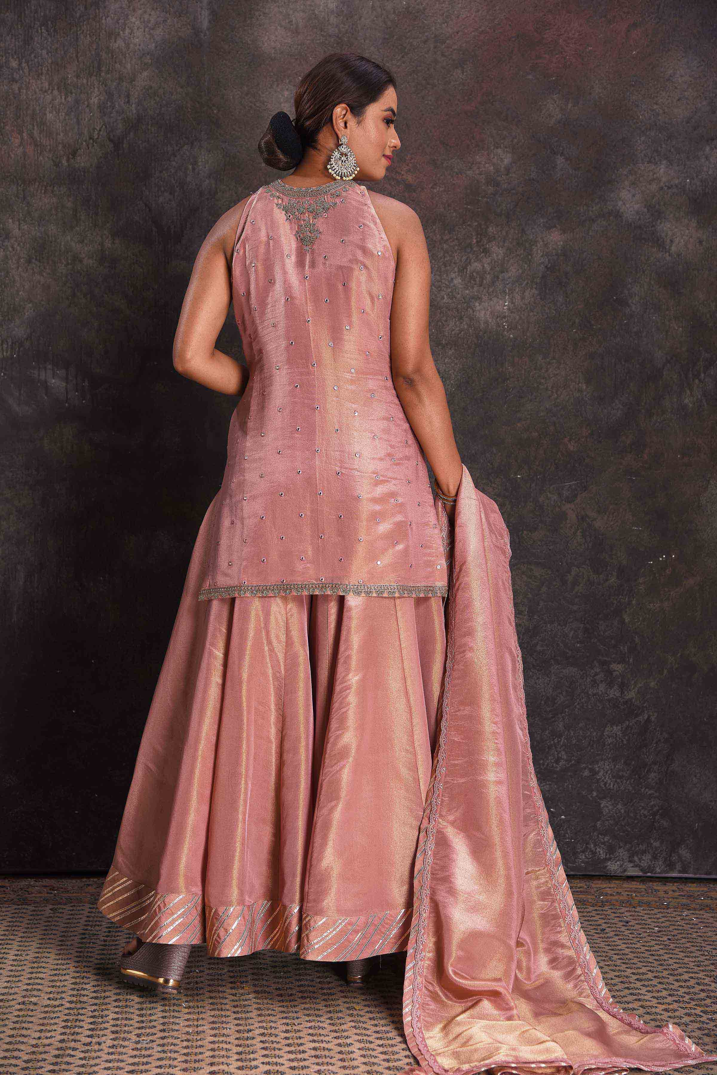 Buy stunning golden pink mirror work sharara suit online in USA with dupatta. Look your ethnic best on festive occasions with latest designer sarees, pure silk sarees, Kanchipuram silk sarees, designer dresses, Anarkali suits, gown, embroidered sarees from Pure Elegance Indian fashion store in USA.-back