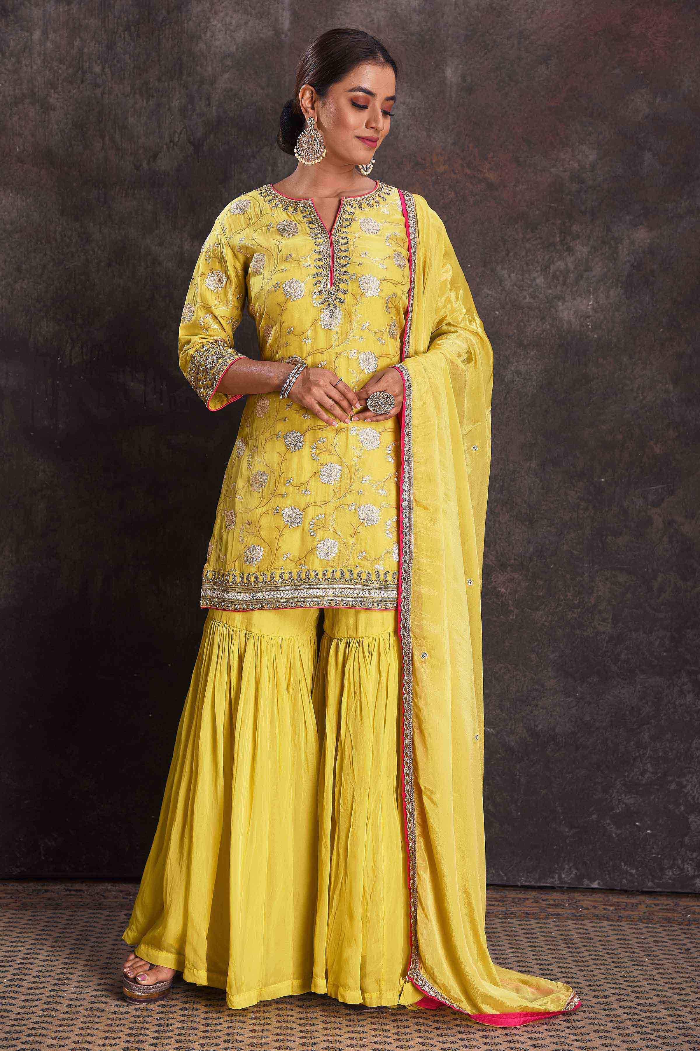 Buy beautiful bright yellow designer embroidered gharara suit online in USA with dupatta. Look your ethnic best on festive occasions with latest designer sarees, pure silk sarees, Kanchipuram silk sarees, designer dresses, Anarkali suits, gown, embroidered sarees from Pure Elegance Indian fashion store in USA.-front