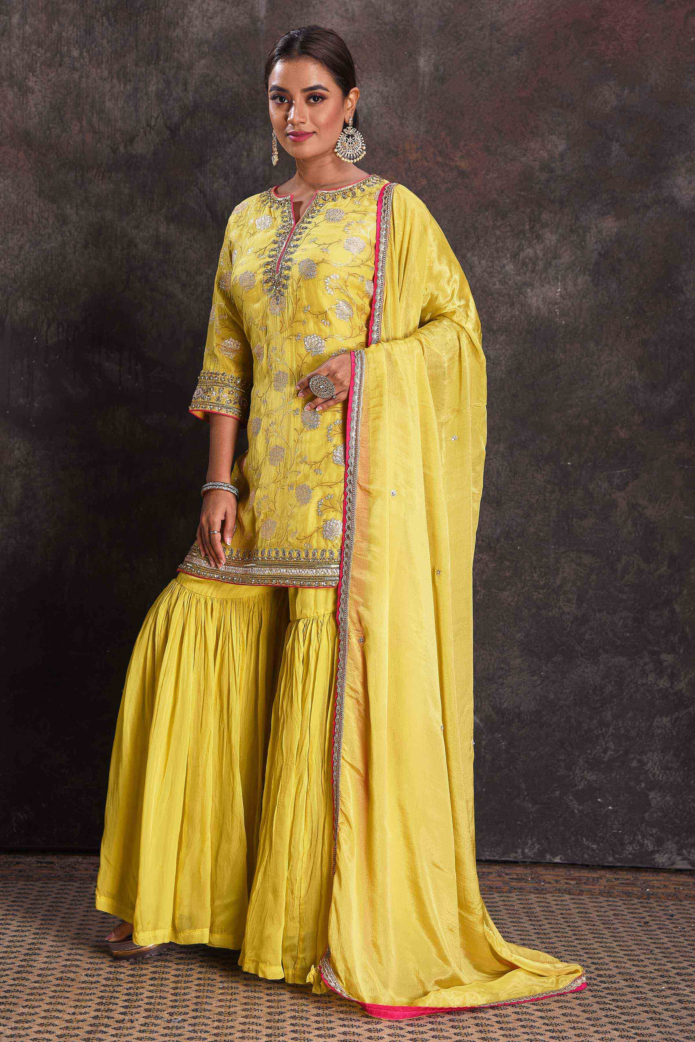 Buy beautiful bright yellow designer embroidered gharara suit online in USA with dupatta. Look your ethnic best on festive occasions with latest designer sarees, pure silk sarees, Kanchipuram silk sarees, designer dresses, Anarkali suits, gown, embroidered sarees from Pure Elegance Indian fashion store in USA.-side