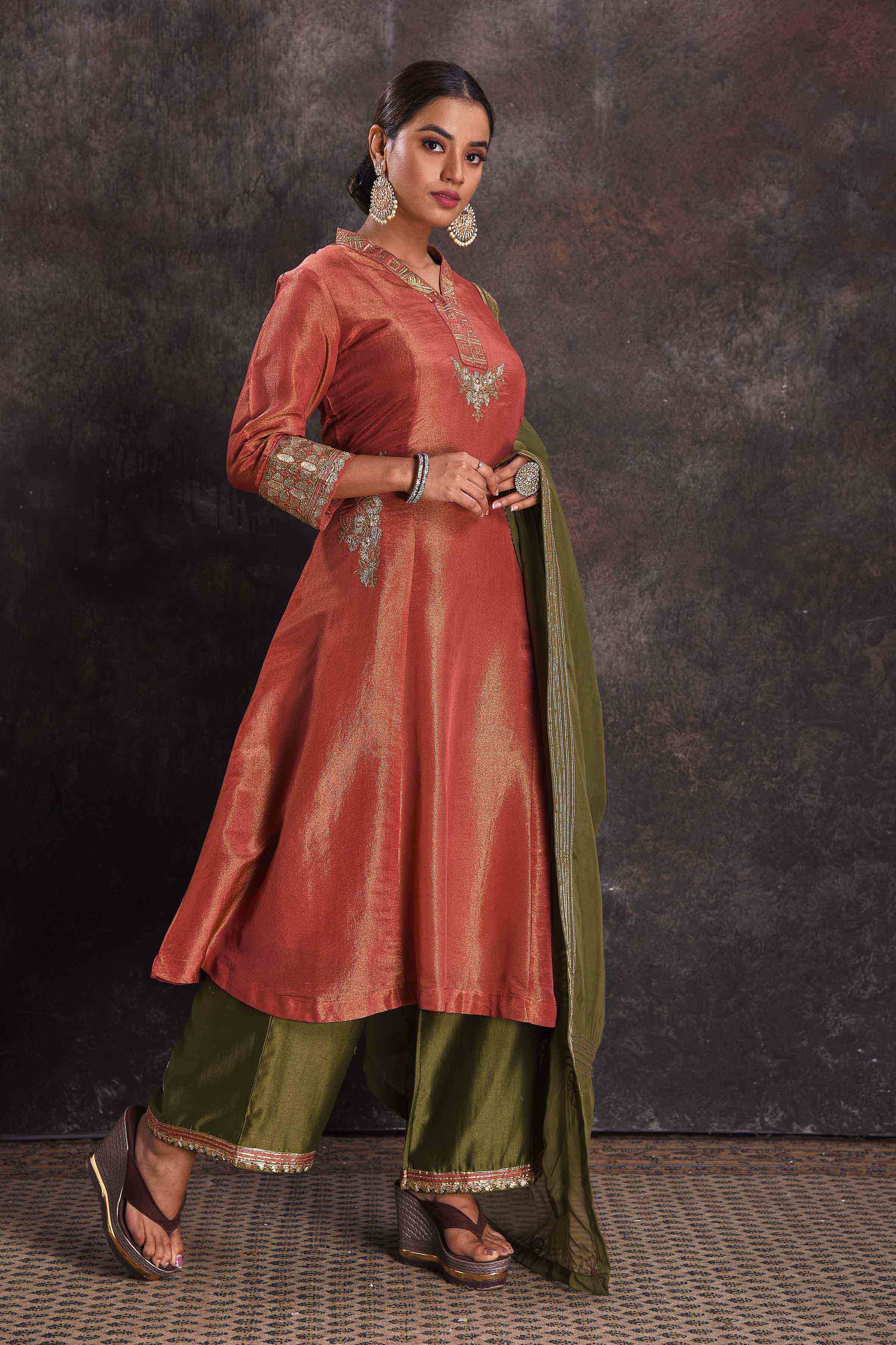 Buy stunning metallic orange embroidered Anarkali suit online in USA with green dupatta. Look your ethnic best on festive occasions with latest designer sarees, pure silk sarees, Kanchipuram silk sarees, designer dresses, Anarkali suits, gown, embroidered sarees from Pure Elegance Indian fashion store in USA.-side