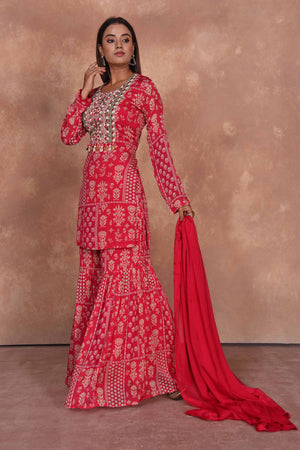 Buy red printed and embroidered sharara suit online in USA with dupatta. Dazzle on weddings and special occasions with exquisite Indian designer dresses, embroidered sarees, partywear sarees, Bollywood sarees, handloom sarees, designer lehenga, Anarkali suits from Pure Elegance Indian clothing store in USA.-left