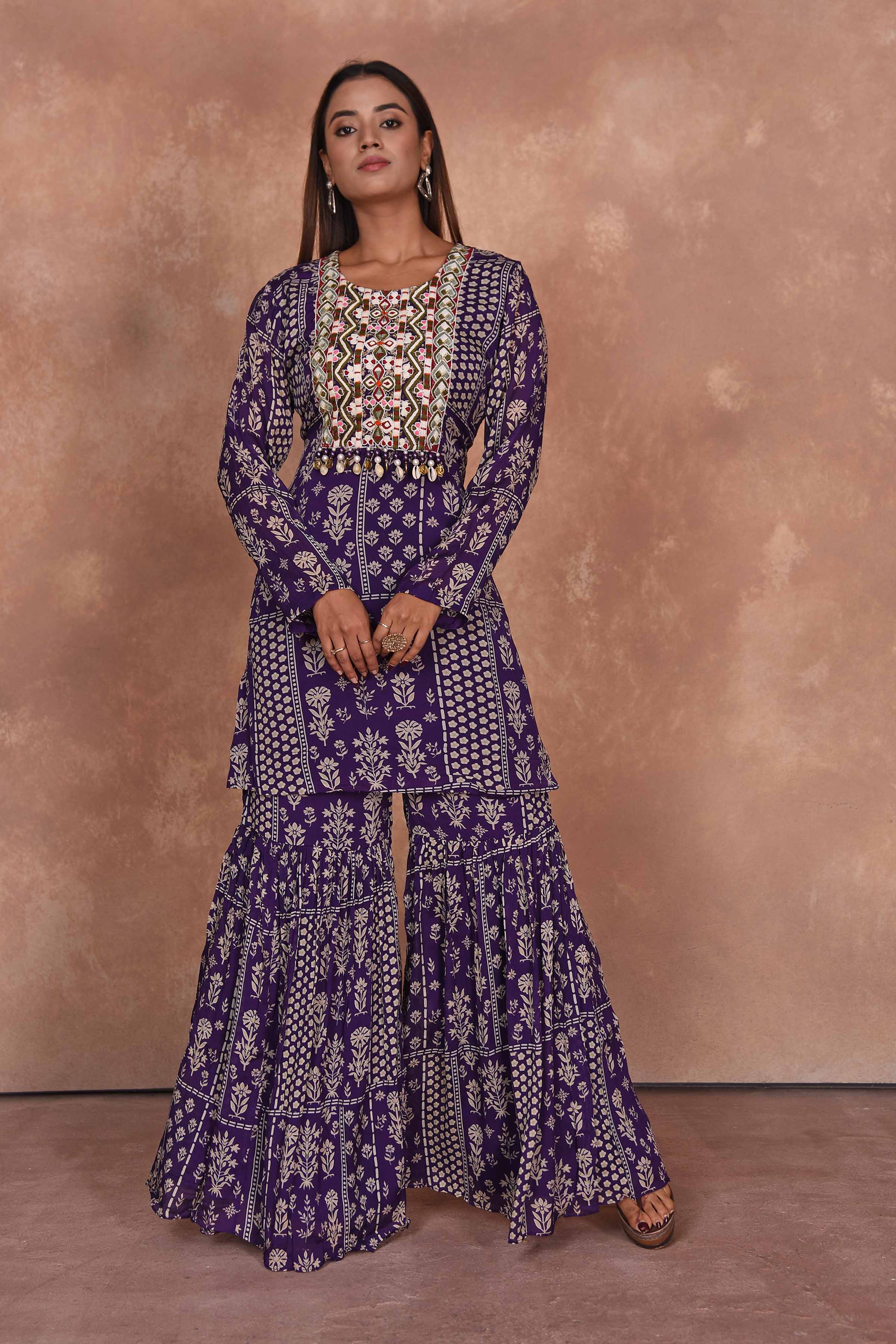 Shop purple printed and embroidered sharara suit online in USA with dupatta. Dazzle on weddings and special occasions with exquisite Indian designer dresses, embroidered sarees, partywear sarees, Bollywood sarees, handloom sarees, designer lehenga, Anarkali suits from Pure Elegance Indian clothing store in USA.-front