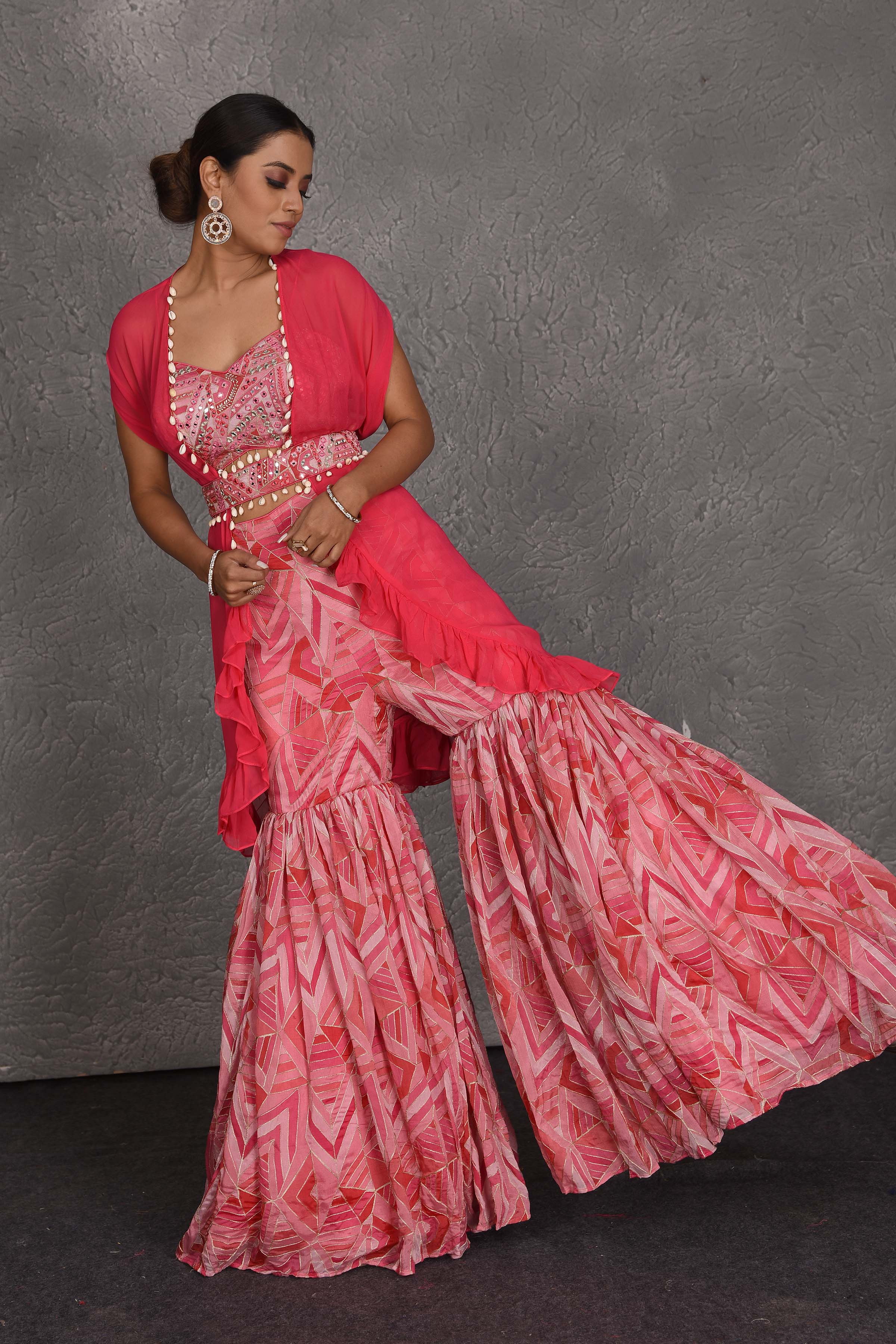 Shop pink printed sharara suit online in USA with shrug and belt. Flaunt your Indian style on festive occasions in stunning designer lehengas, Anarkali suit, sharara suits, designer gowns, designer sarees, embroidered sarees from Pure Elegance India fashion store in USA. -front